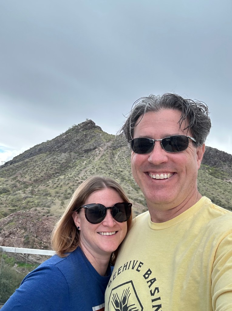 Nathan and Mandy in Arizona with mountains behind them.